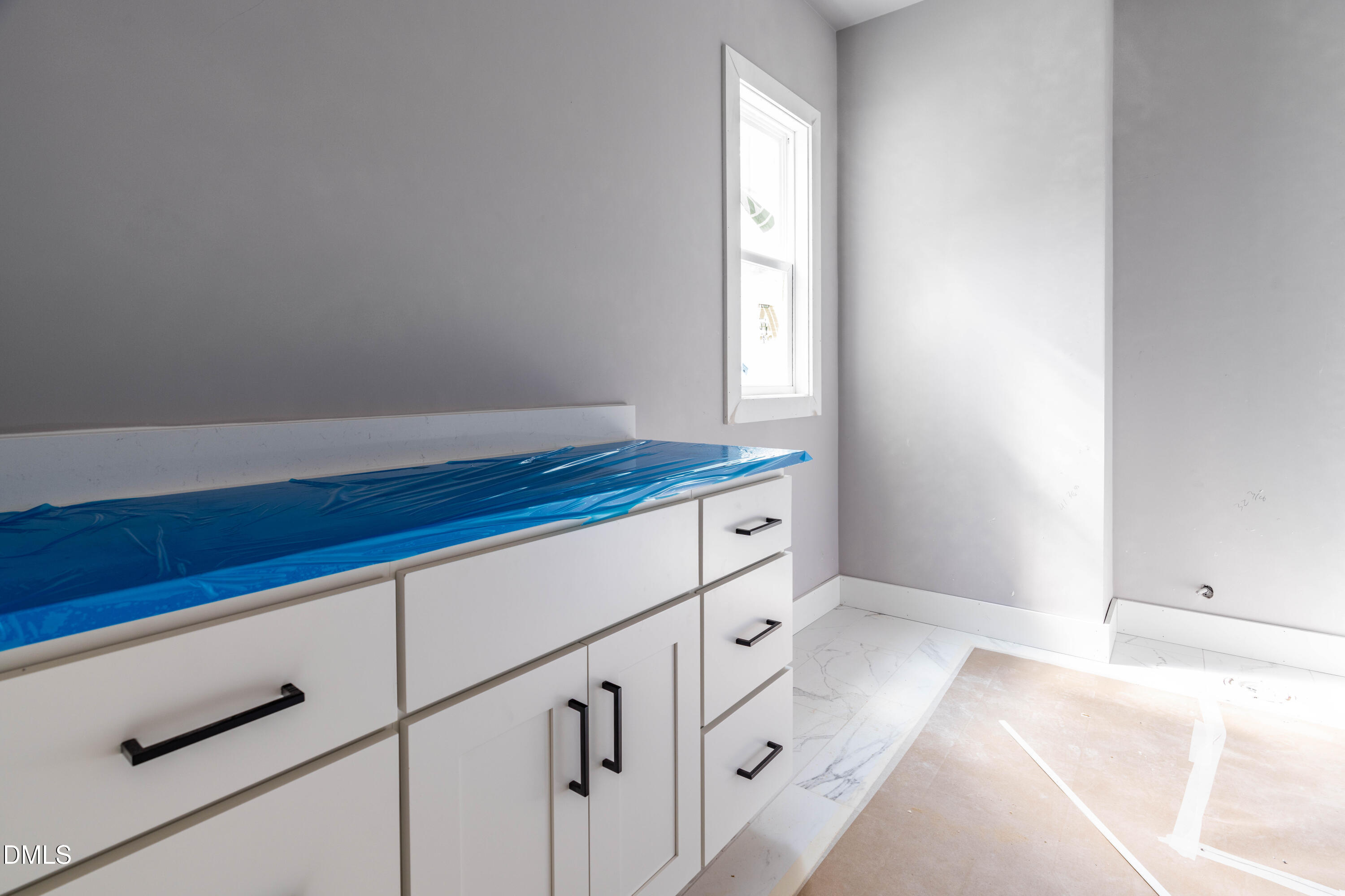 1032 Harper Road Raleigh, NC 27603 - Photo 10 of 62 a kitchen with white cabinets and window