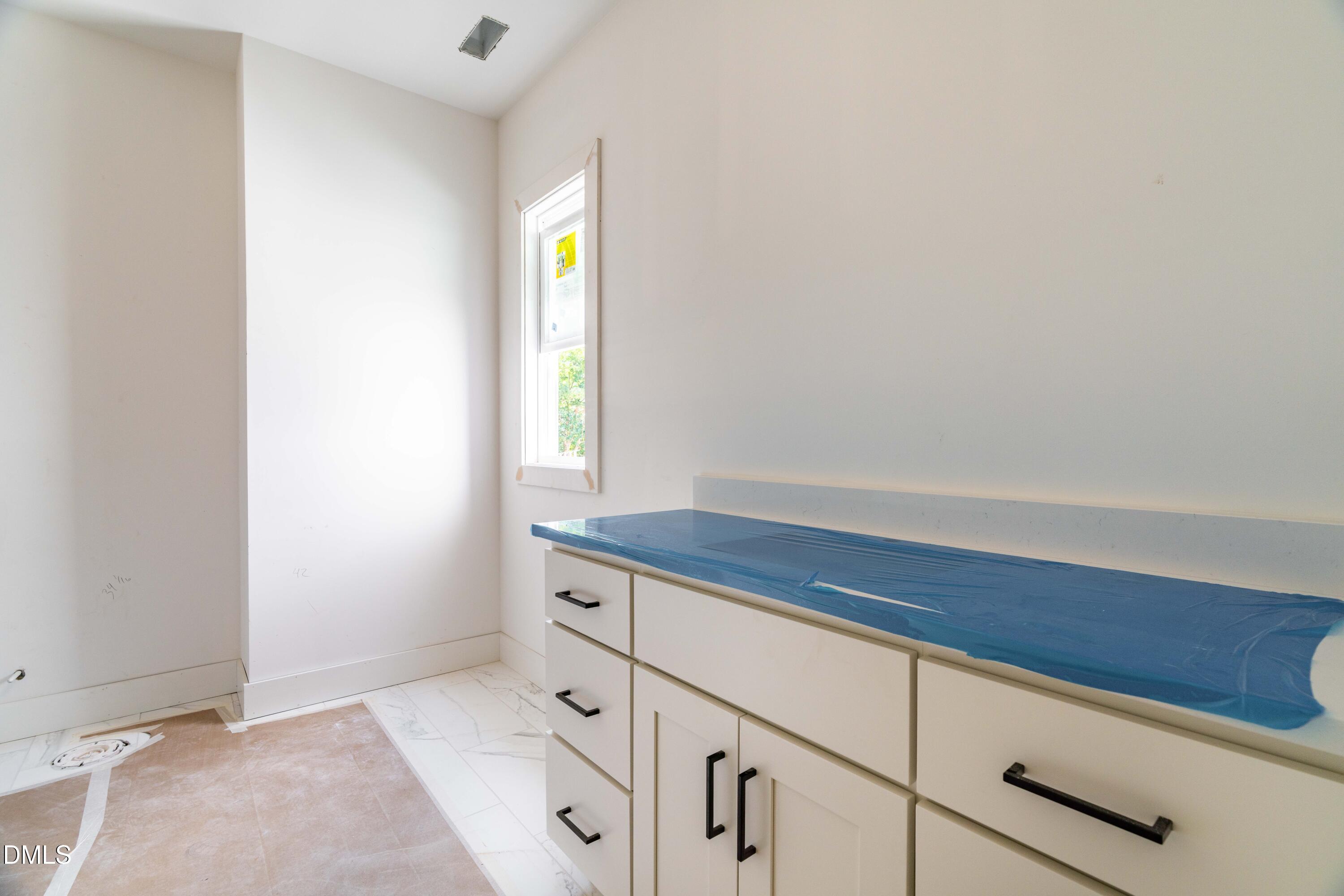 1032 Harper Road Raleigh, NC 27603 - Photo 13 of 62 a bathroom with a sink and vanity