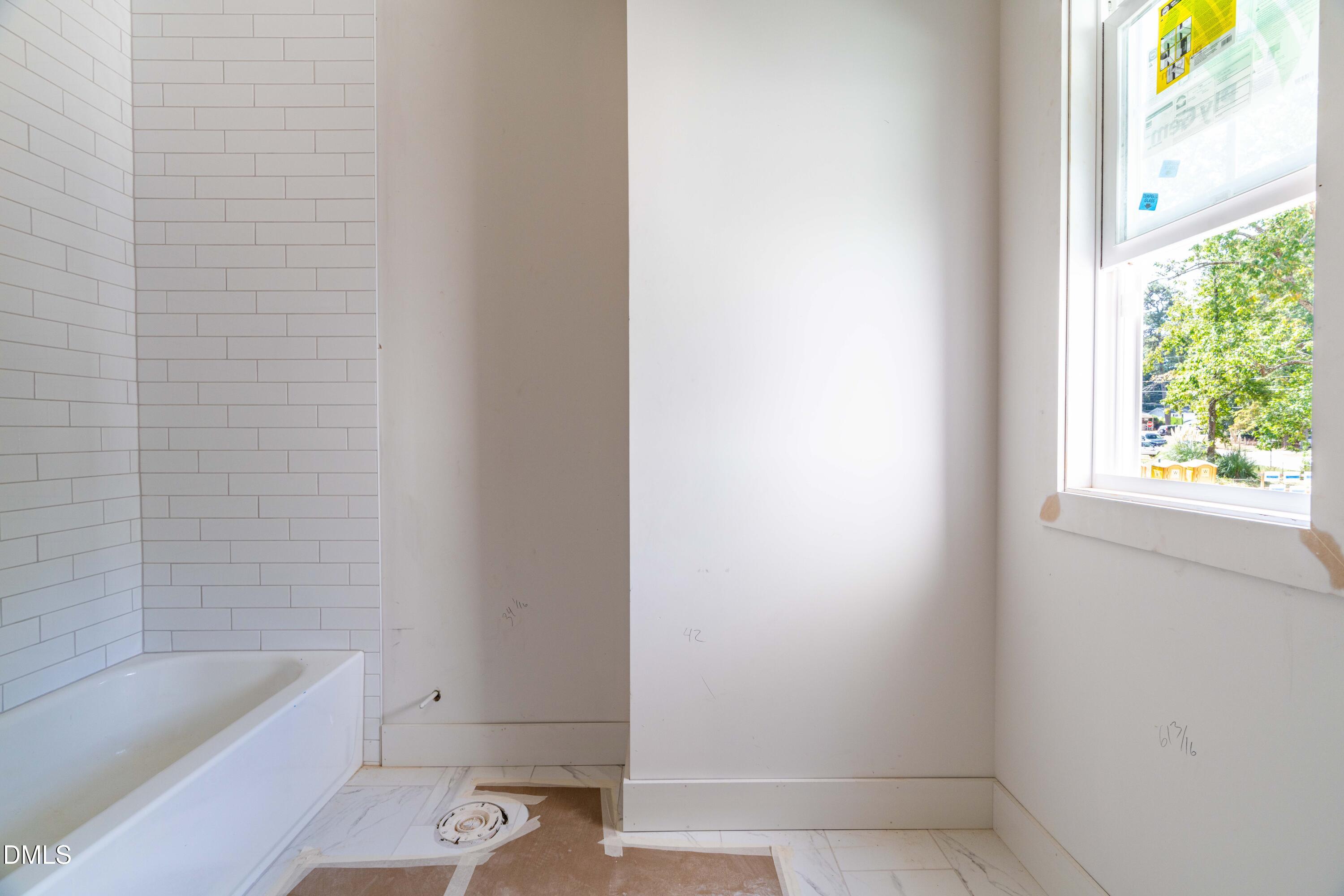 1032 Harper Road Raleigh, NC 27603 - Photo 15 of 62 a bathroom with a bathtub