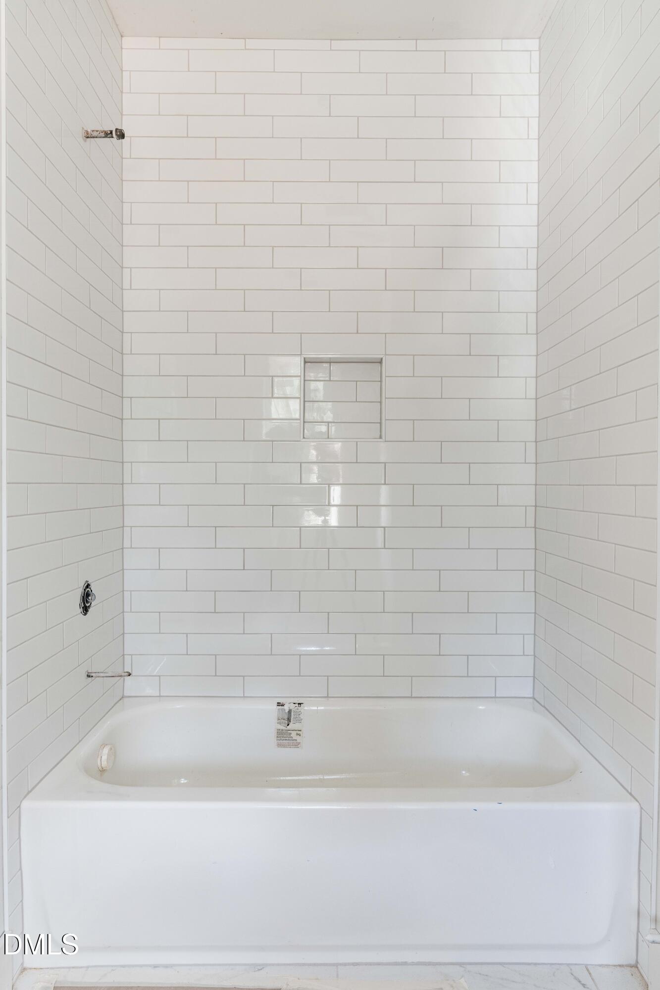 1032 Harper Road Raleigh, NC 27603 - Photo 16 of 62 a bathroom with a bathtub and a shower