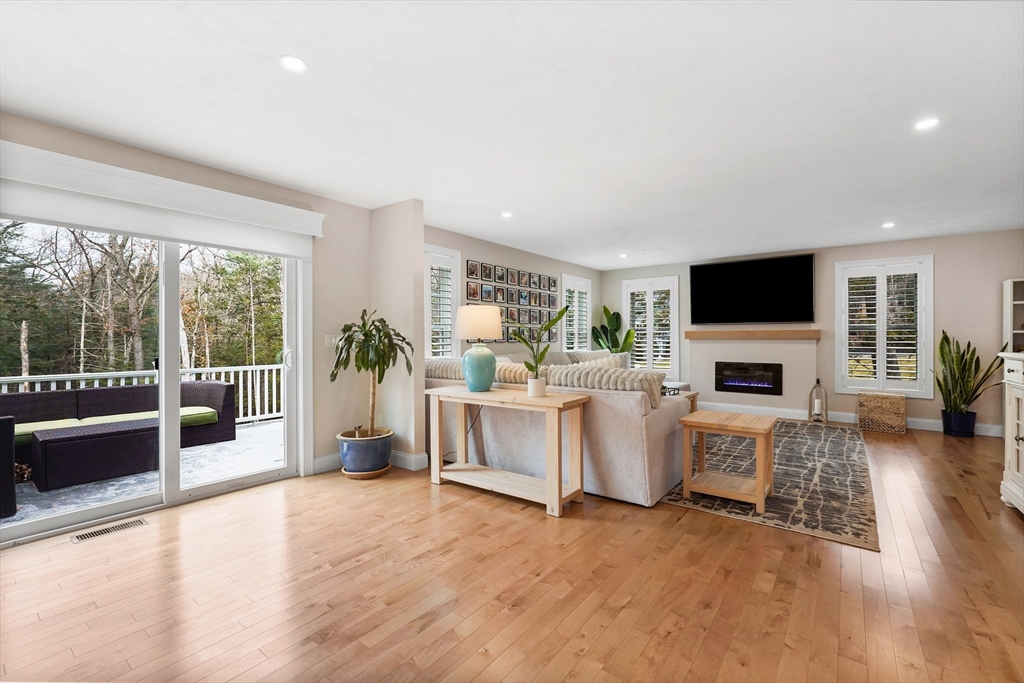 61 New Boston Road Sturbridge, MA 01566 - Photo 21 of 42 a living room with furniture a flat screen tv and a fireplace
