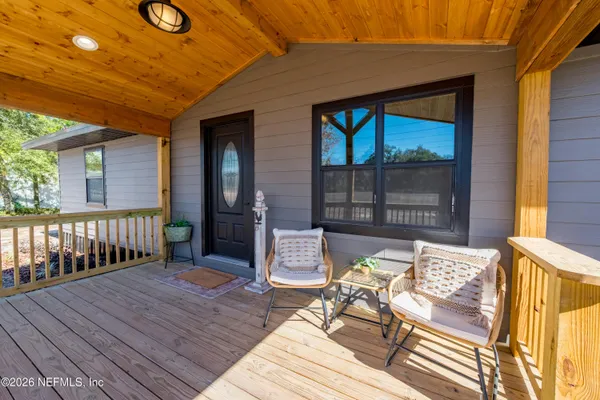 a balcony with furniture and wooden floor