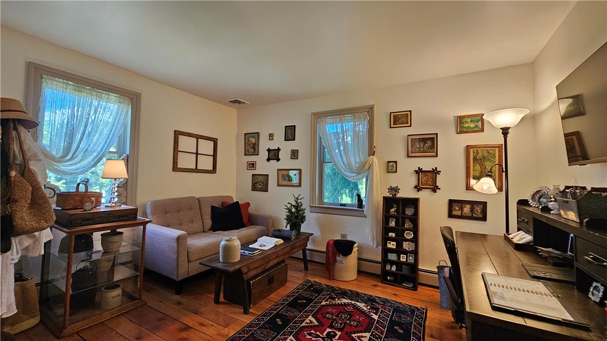 585 Buttermilk Road Hellertown, PA 18055 - Photo 34 of 82 Natural light illuminates rich hardwood flooring in this cozy, inviting living space.