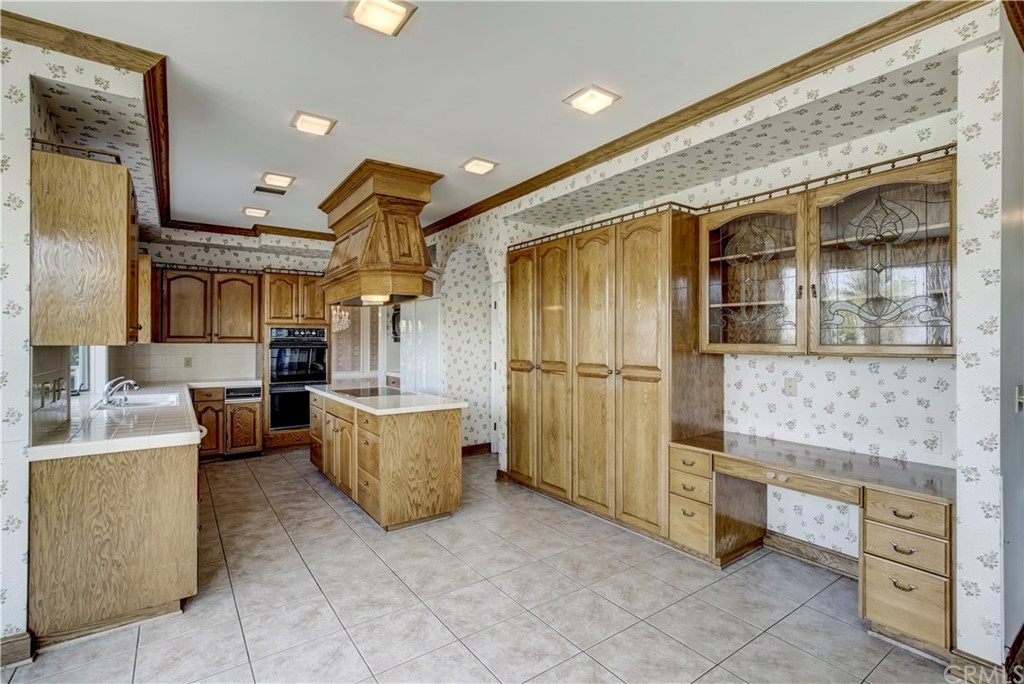 1632 Smiley Heights Drive Redlands, CA 92373 - Photo 16 of 75 a kitchen with refrigerator and cabinets
