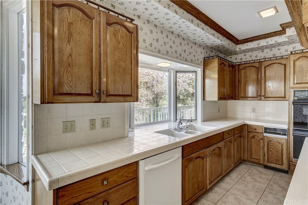 1632 Smiley Heights Drive Redlands, CA 92373 - Photo 17 of 75 a kitchen with stainless steel appliances a sink and cabinets