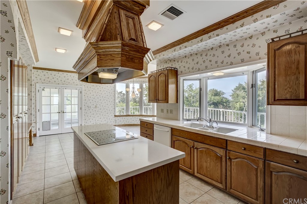 1632 Smiley Heights Drive Redlands, CA 92373 - Photo 18 of 75 a kitchen with stainless steel appliances granite countertop a sink a counter space wooden floor and a large window