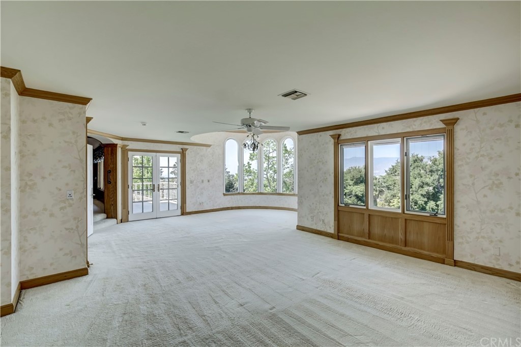 1632 Smiley Heights Drive Redlands, CA 92373 - Photo 40 of 75 a view of an empty room with a fireplace and a window