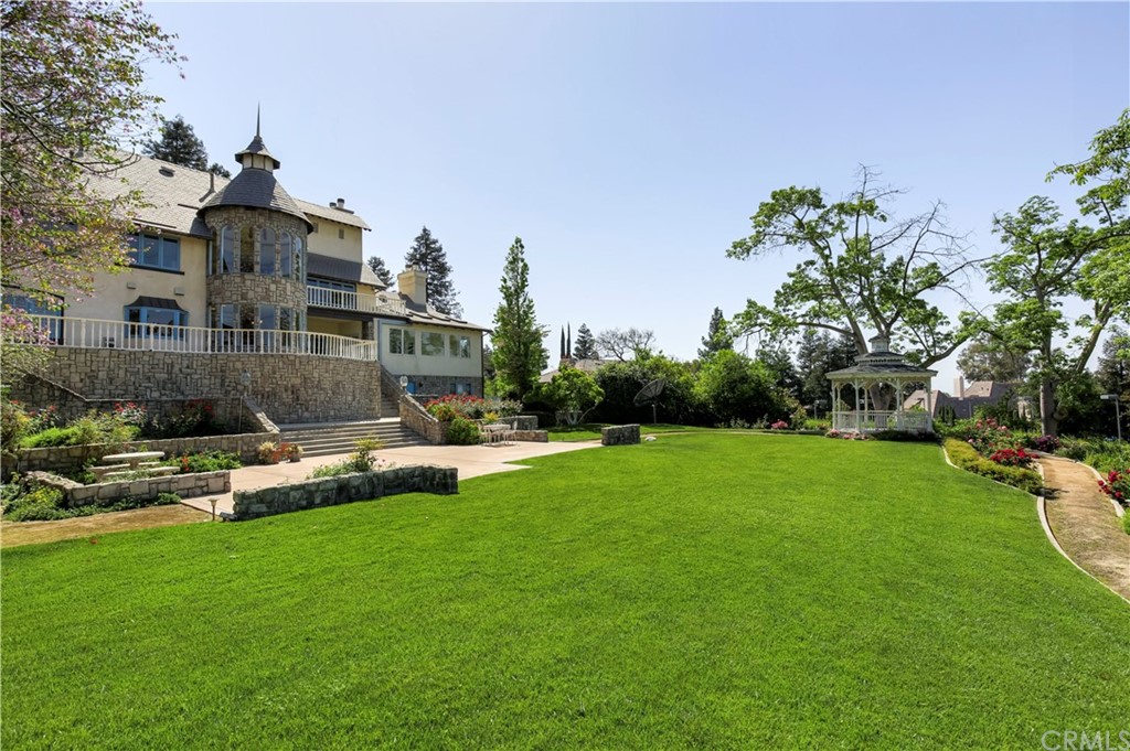 1632 Smiley Heights Drive Redlands, CA 92373 - Photo 62 of 75 a front view of a house with a garden and swimming pool
