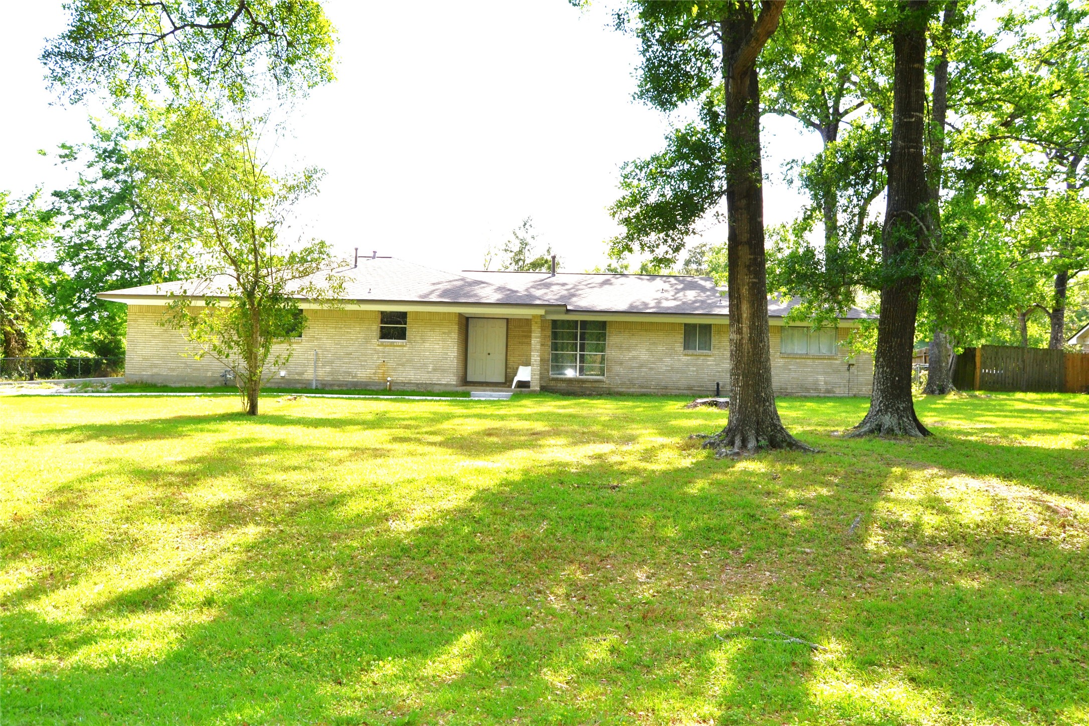 101 Summit Drive Conroe, TX 77303 - Photo 23 of 24 a view of swimming pool with lawn chairs and large trees
