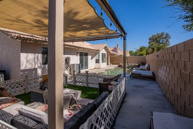a view of a house with swimming pool and sitting area