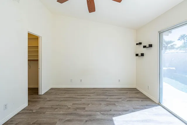 an empty room with wooden floor