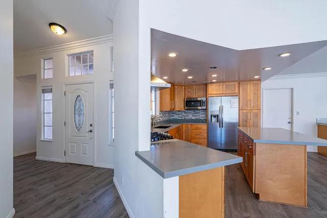 a view of a kitchen with furniture and wooden floor