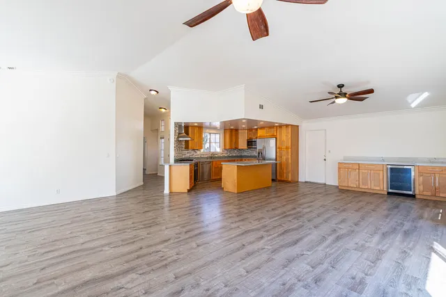 a large kitchen with granite countertop a stove and a wooden floor