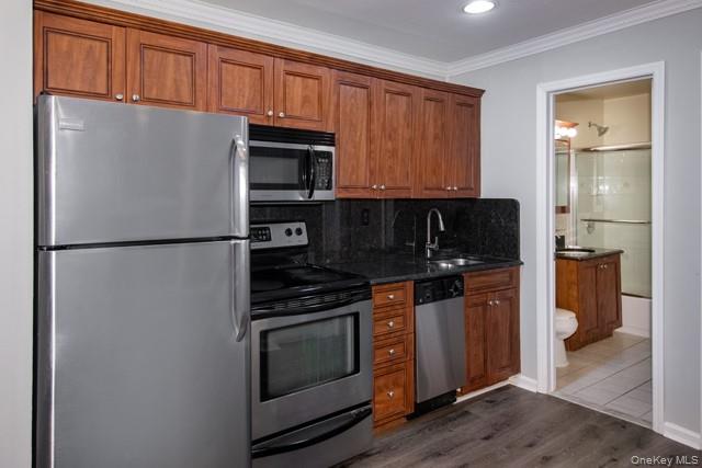 387 C Great East Neck Road, Unit 387C West Babylon, NY 11704 - Photo 2 of 9 a kitchen with stainless steel appliances granite countertop a refrigerator stove and sink