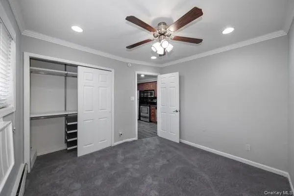 an empty room with closet and fan