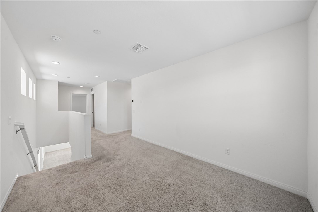 20130 Curaco Court Riverside, CA 92507 - Photo 22 of 43 Upstairs loft area with recessed lighting and neutral carpet.