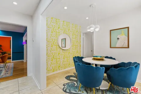 a dining room with furniture a mirror and outdoor view
