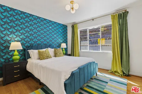 a bedroom with a bed and a chandelier