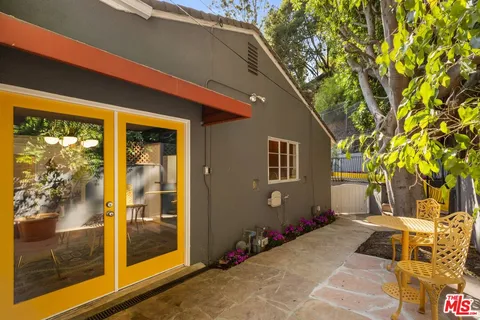 a backyard of a house with table and chairs
