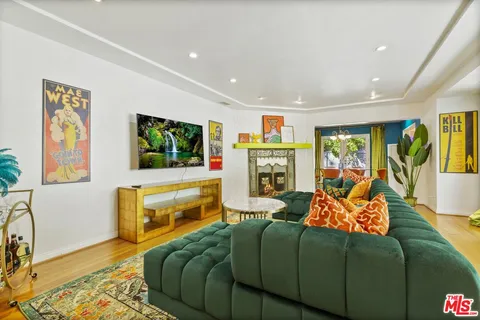 a living room with furniture flat screen tv and a couch