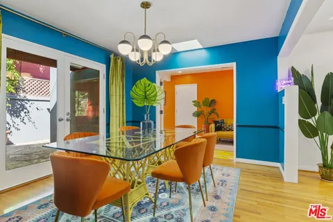 a dining room dining table with chairs and chandelier