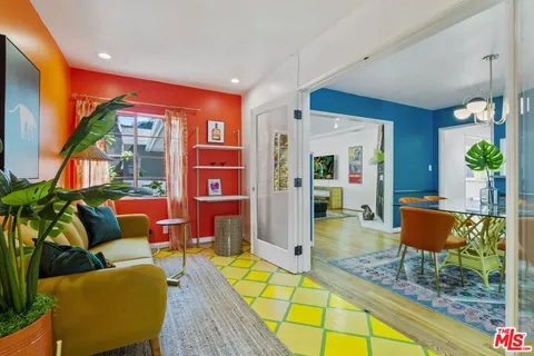 a living room with furniture a rug and a potted plant
