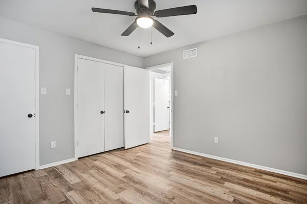 a view of empty room with wooden floor