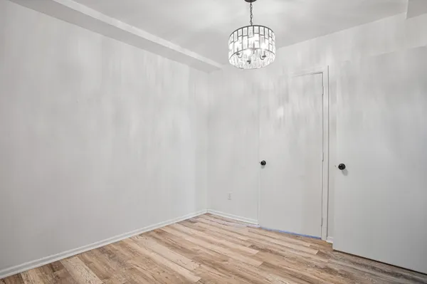 an empty room with wooden floor