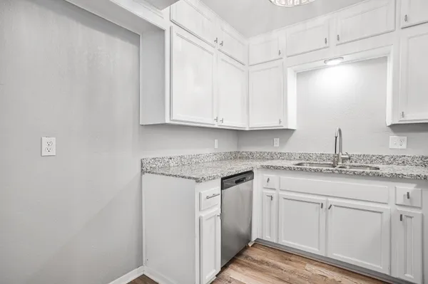 a kitchen with granite countertop white cabinets and a white counter top