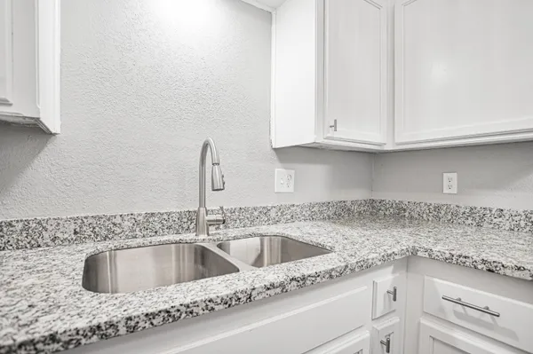 a kitchen with stainless steel appliances granite countertop a stove and a sink
