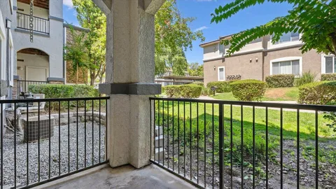 a view of a brick house with large windows
