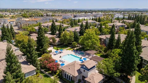 an aerial view of a houses with a lake