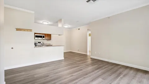 a view of kitchen with granite countertop cabinets and wooden floor