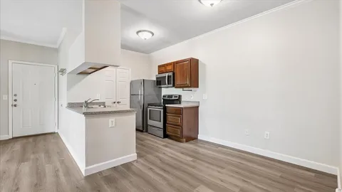 a kitchen with a refrigerator and a stove top oven