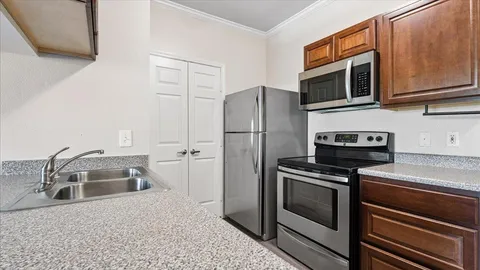 a kitchen with a refrigerator stove and microwave