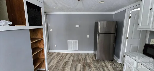 a view of walk in closet with empty racks