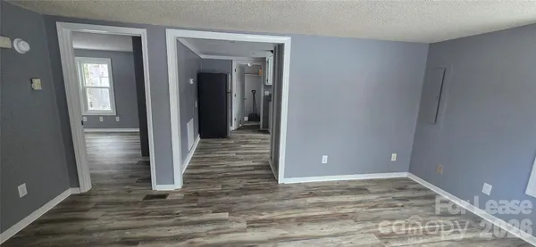 a view of a small space with wooden floor and closet