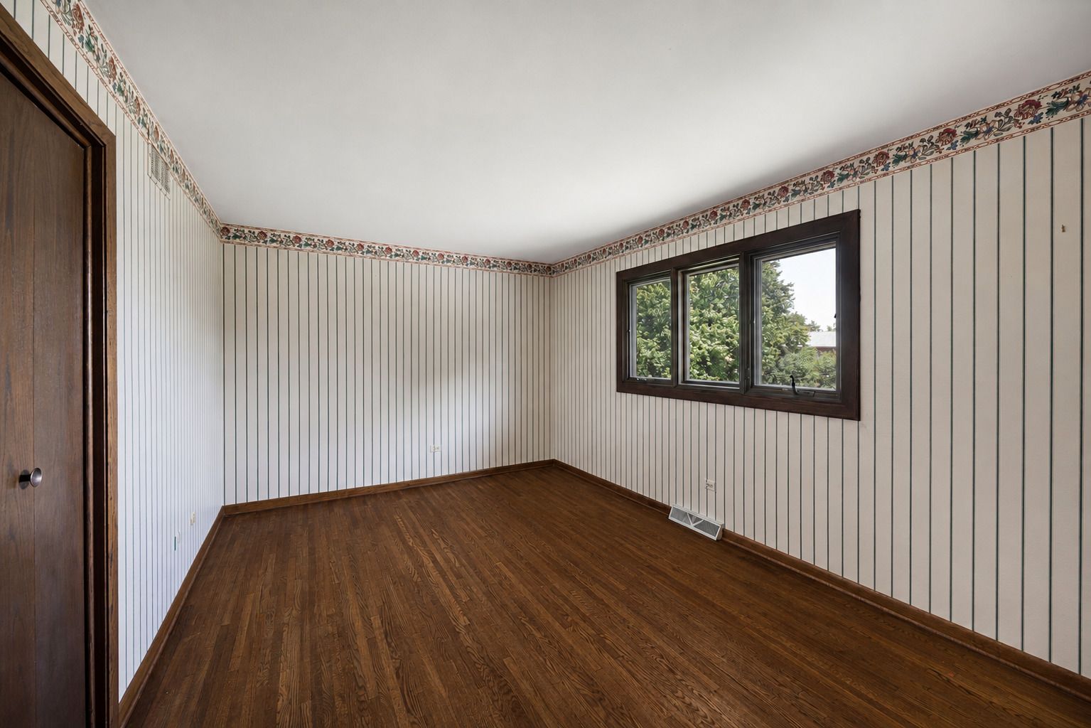 6723 Kingswood Road Willowbrook, IL 60527 - Photo 32 of 51 a view of an empty room with wooden floor and a window