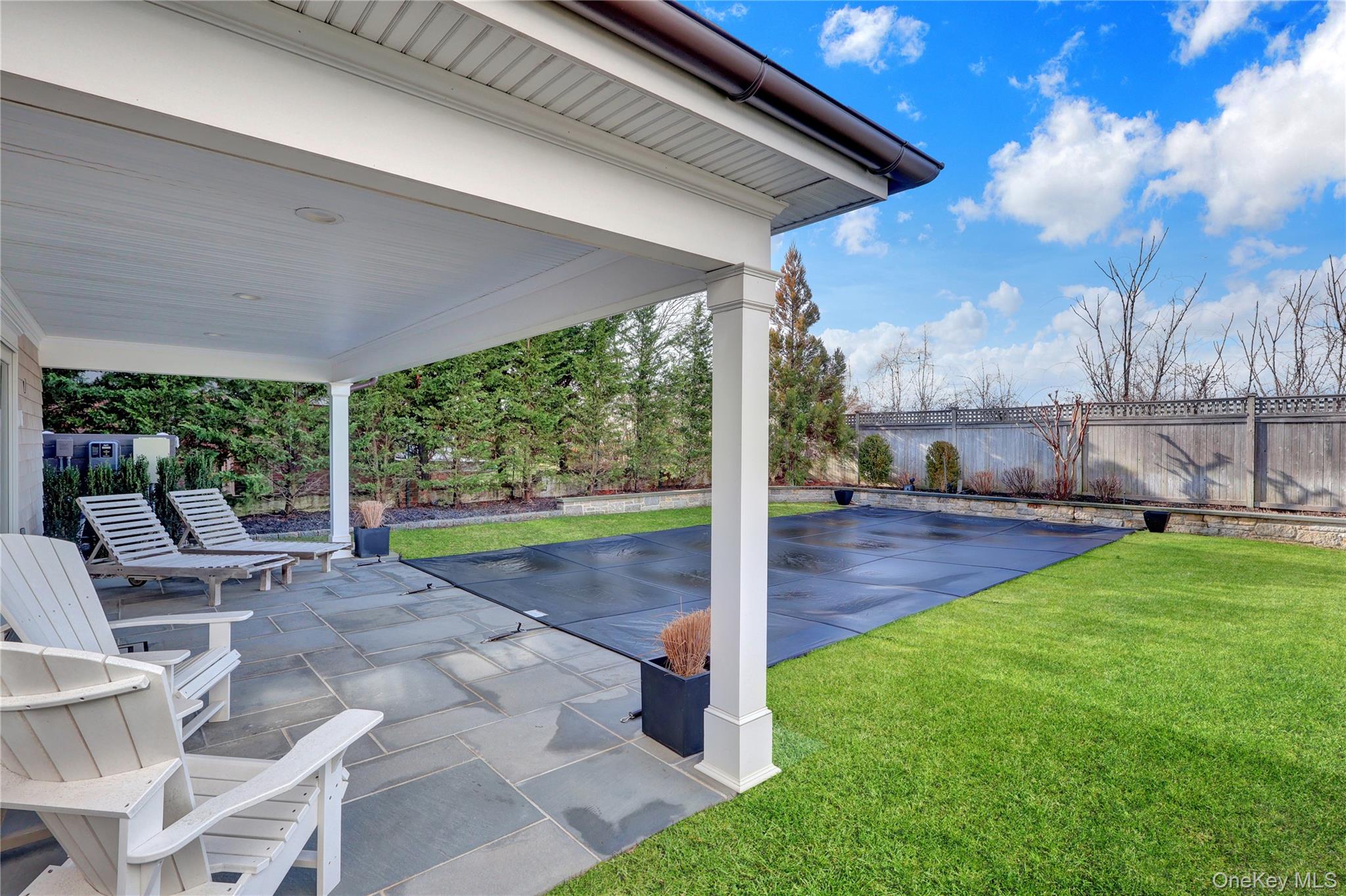 99 Parkside Drive Point Lookout, NY 11569 - Photo 39 of 50 a view of a patio with a table chairs potted plants and palm tree