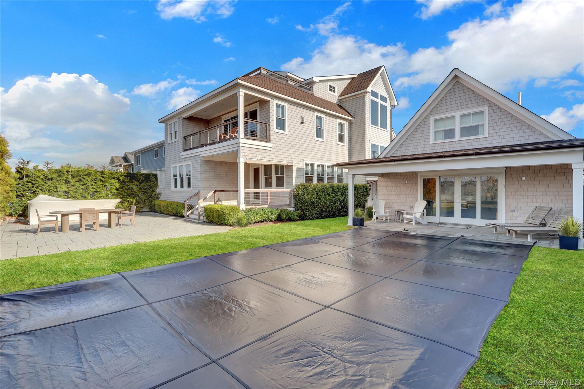 99 Parkside Drive Point Lookout, NY 11569 - Photo 41 of 50 a front view of a house with a yard and potted plants