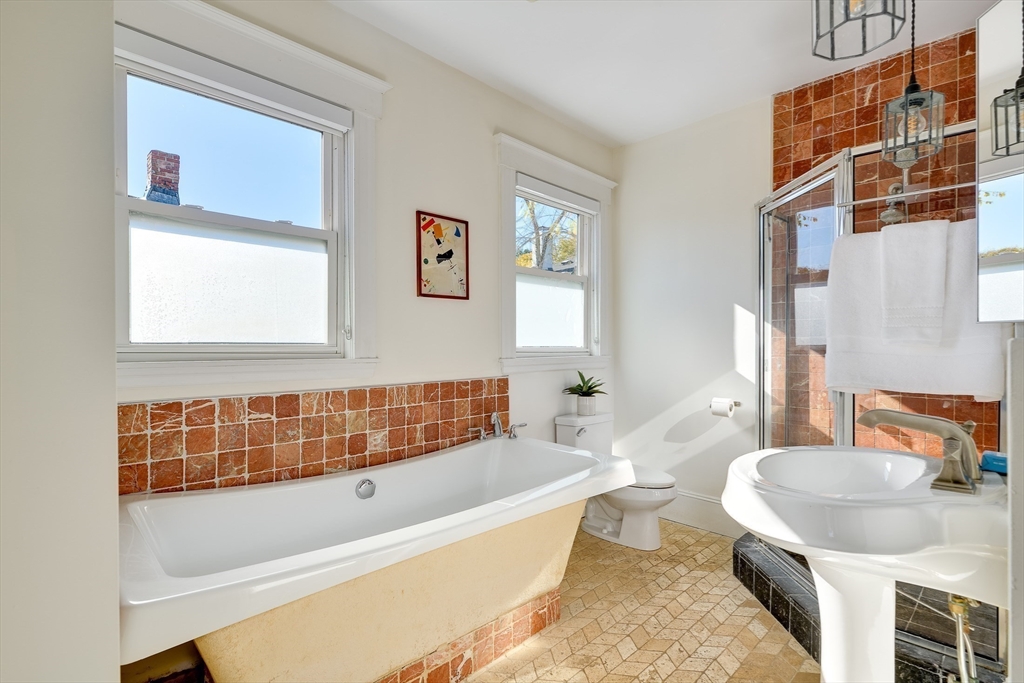 161 Columbia Street, Unit 3 Cambridge, MA 02139 - Photo 11 of 19 a bathroom with a tub a sink and a window