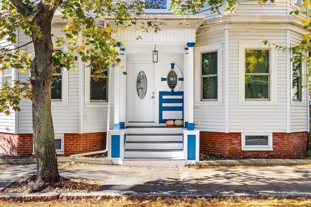 161 Columbia Street, Unit 3 Cambridge, MA 02139 - Photo 17 of 19 a view of a house with a tree and wooden fence