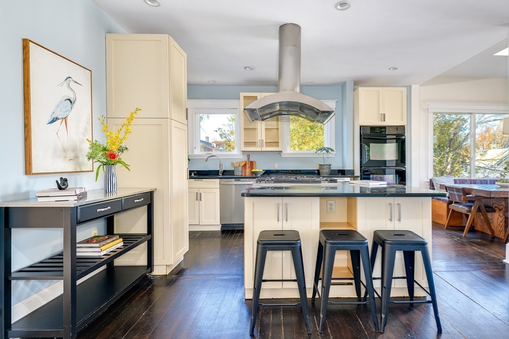 161 Columbia Street, Unit 3 Cambridge, MA 02139 - Photo 4 of 19 a kitchen with stainless steel appliances granite countertop a stove and chairs