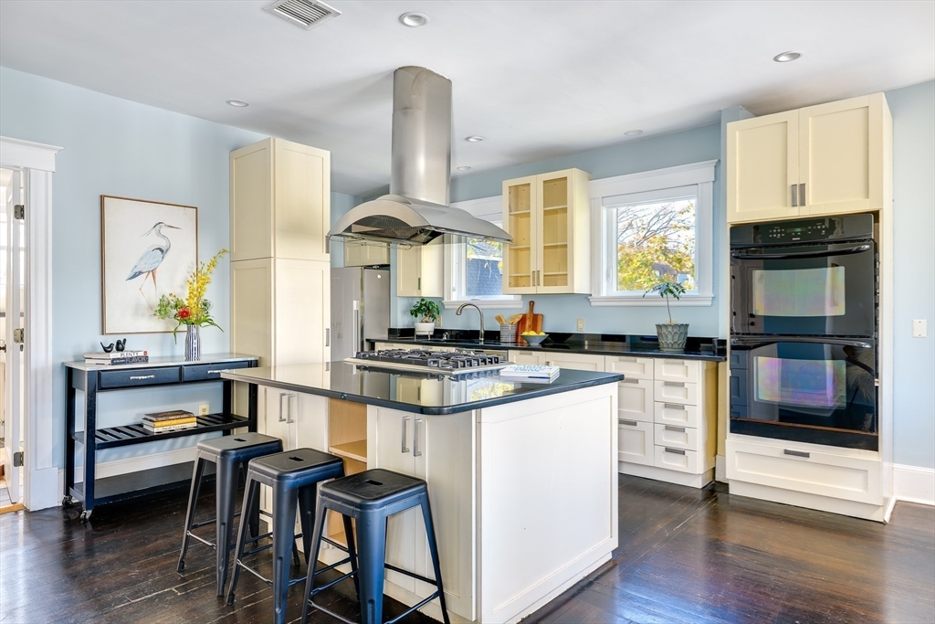 161 Columbia Street, Unit 3 Cambridge, MA 02139 - Photo 5 of 19 a kitchen with stainless steel appliances a stove a table chairs and a window