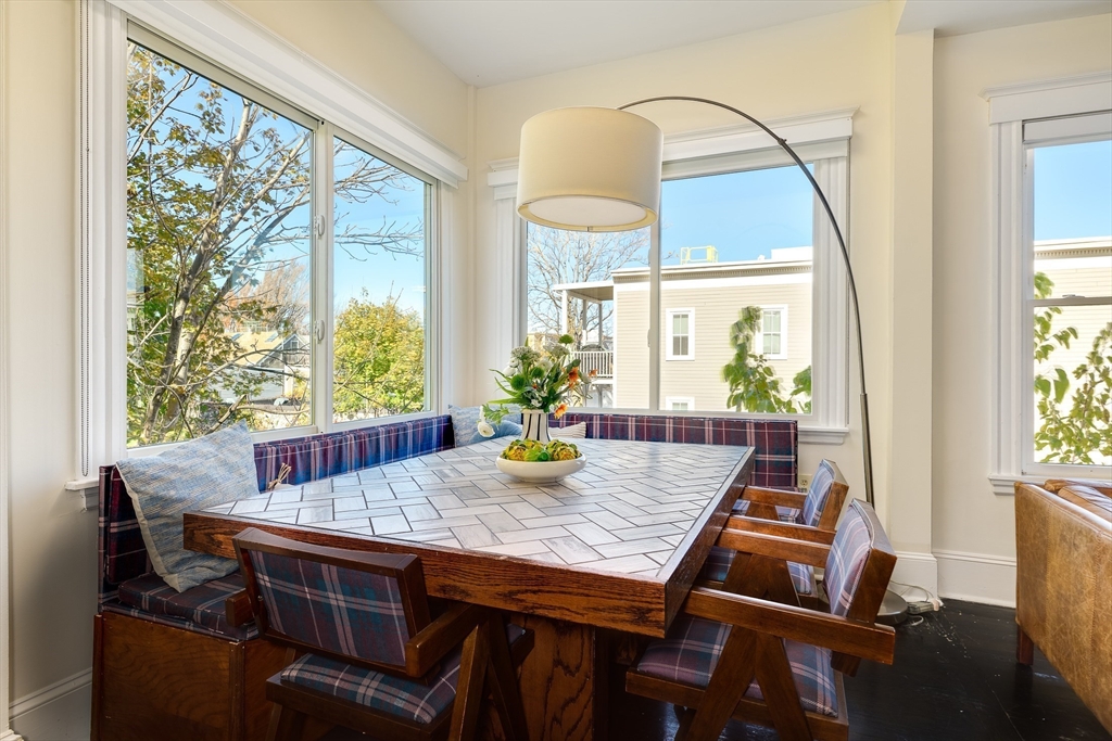 161 Columbia Street, Unit 3 Cambridge, MA 02139 - Photo 6 of 19 a view of a dining room with furniture window and wooden floor