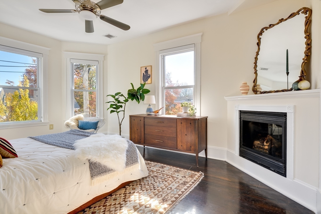 161 Columbia Street, Unit 3 Cambridge, MA 02139 - Photo 9 of 19 a bedroom with a bed and a fireplace