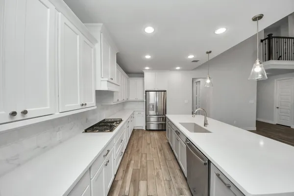 a kitchen with a sink and white cabinets