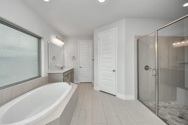 a bathroom with a sink a tub and mirror