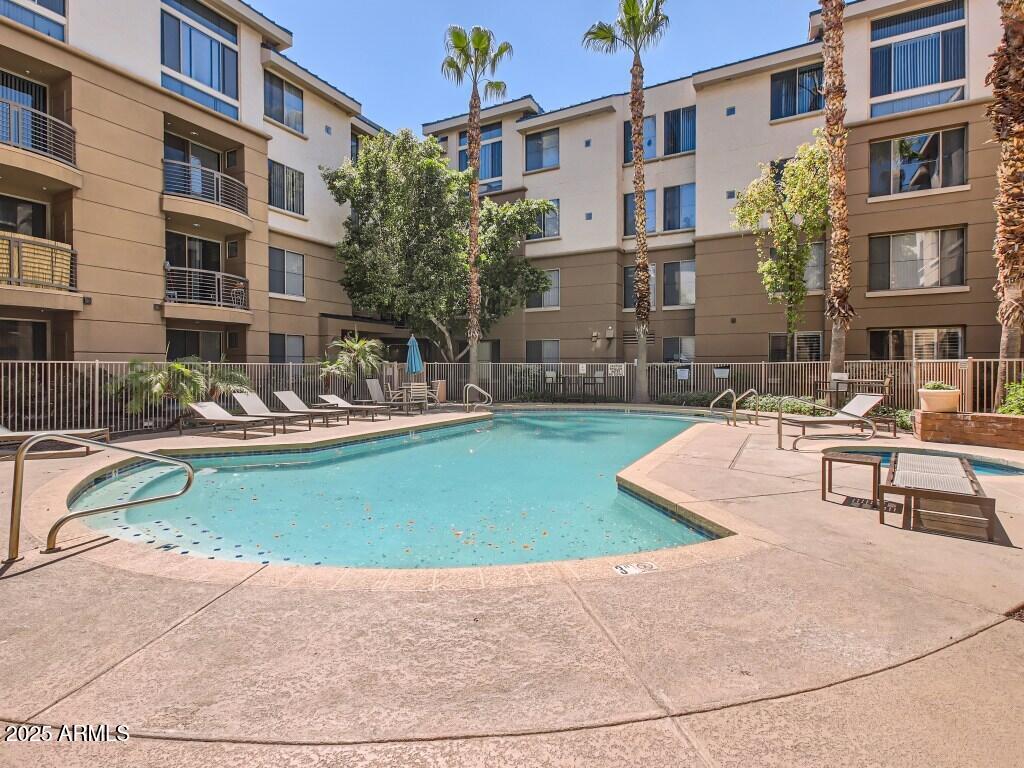 1701 East Colter Street, Unit 370 Phoenix, AZ 85016 - Photo 13 of 20 a view of a swimming pool with a lounge chairs