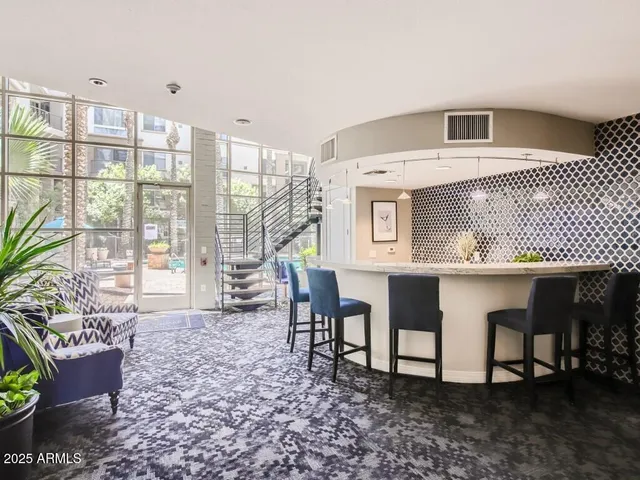 a living room with furniture a dining table and chairs with kitchen view